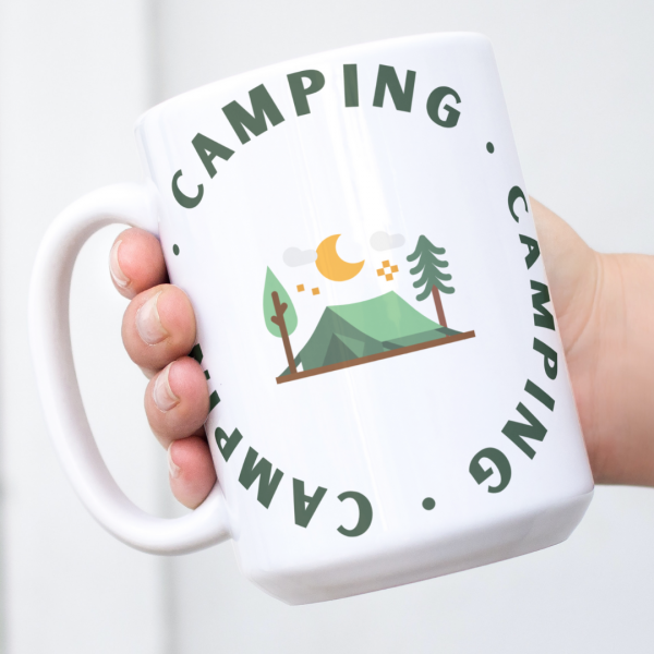 White mug with camping design featuring a tent, trees, moon, and circular Camping text